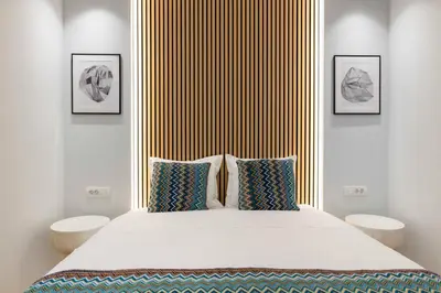 a bedroom with a large bed with two pillows at Voukourestiou Grand Residence 56 in Athens