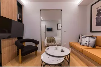 a living room with a couch and a table at Voukourestiou Grand Residence 56 in Athens