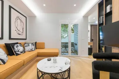 a living room with a couch and a table at Voukourestiou Grand Residence 56 in Athens