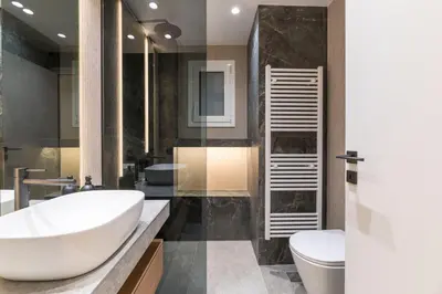 a bathroom with a white sink and a toilet at Voukourestiou Grand Residence 56 in Athens