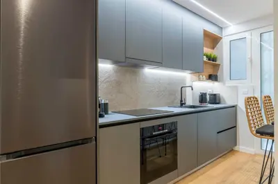 a kitchen with a stainless steel refrigerator at Voukourestiou Grand Residence 56 in Athens