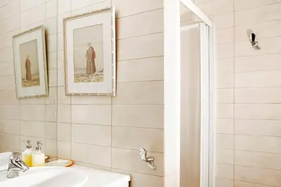 a white bathroom with a sink and a mirror at Casa Taylor 4BR with private pool and sea view in Lagonissi