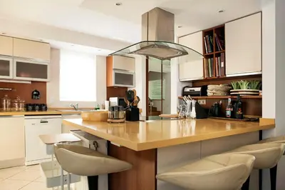 a kitchen with a large island with white cabinets at Casa Taylor 4BR with private pool and sea view in Lagonissi
