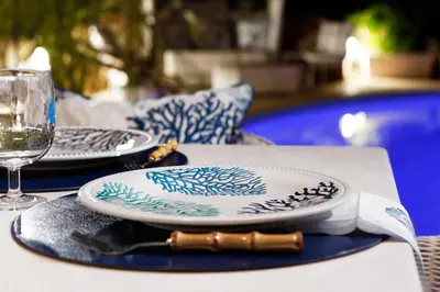 a table with two plates and a glass of wine at Casa Taylor 4BR with private pool and sea view in Lagonissi