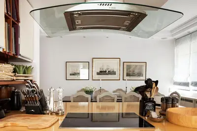 a kitchen with a large chandelier above a counter at Casa Taylor 4BR with private pool and sea view in Lagonissi