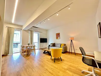 a living room with a couch and a table at Dafne Athens renovated apartment 170m from Metro in Athens