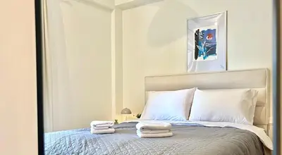 a bedroom with a bed with two towels on it at Dafne Athens renovated apartment 170m from Metro in Athens