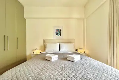 a bedroom with a bed with two towels on it at Dafne Athens renovated apartment 170m from Metro in Athens