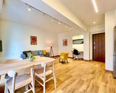 a living room with a table and chairs at Dafne Athens renovated apartment 170m from Metro in Athens