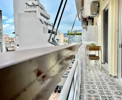 a balcony with a view of a building at Dafne Athens renovated apartment 170m from Metro in Athens