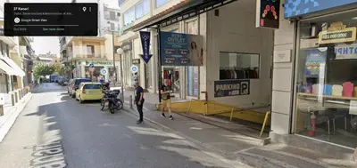 a man standing on a street in a city at Dafne Athens renovated apartment 170m from Metro in Athens