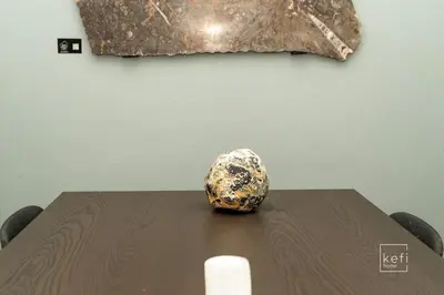 a wooden table with a rock on top of it at Cozy 3-BDR Flat at Tavros Metro - 10 Min to Center in Athens