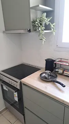 a kitchen counter with a pot on top of a stove at Piraeus Port Rooms in Piraeus