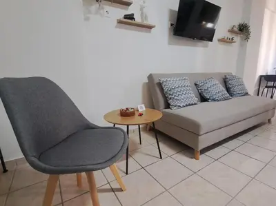 a living room with a couch and a table at Piraeus Port Rooms in Piraeus