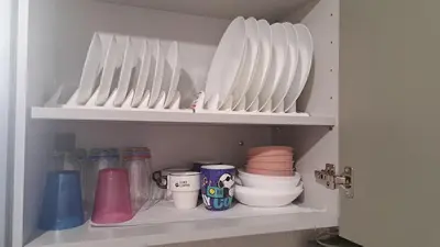 a cabinet with plates and bowls and other dishes at Piraeus Port Rooms in Piraeus