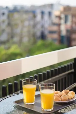 two glasses of orange juice and donuts on a tray at Polis luxury apartment 2 in Athens