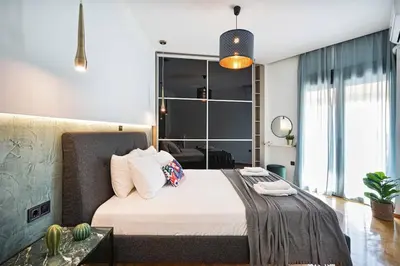 a bedroom with a bed and a large window at Polis luxury apartment 2 in Athens