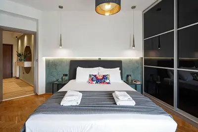 a bedroom with a large bed with towels on it at Polis luxury apartment 2 in Athens