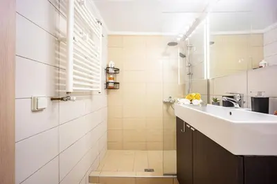 a bathroom with a sink and a shower at Stylish 2BD with Balcony in Central Athens in Athens