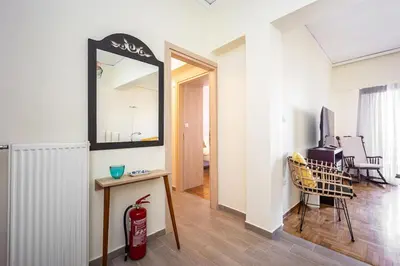 a living room with a fire hydrant and a mirror at Stylish 2BD with Balcony in Central Athens in Athens