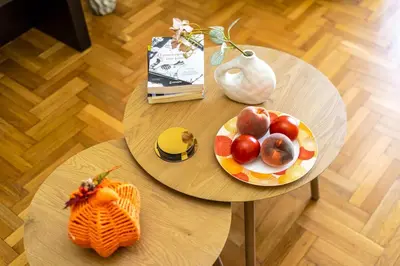 two tables with a plate of fruit and a book at Stylish 2BD with Balcony in Central Athens in Athens