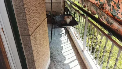 a chair next to a fence with a teddy bear on it at Acharnon home in Athens