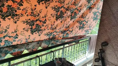 a window with a curtain on a balcony at Acharnon home in Athens