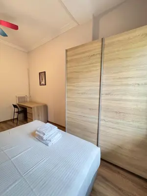 a room with a bed with a large wooden wall at The Ioustinianou Residence in Athens