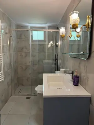 a bathroom with a shower and a sink at The Ioustinianou Residence in Athens