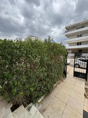 a large green bush in front of a building at The Ioustinianou Residence in Athens