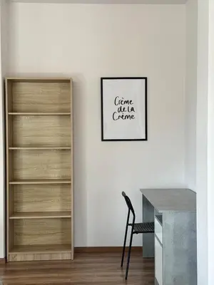 a white room with a desk and a book shelf at The Ioustinianou Residence in Athens