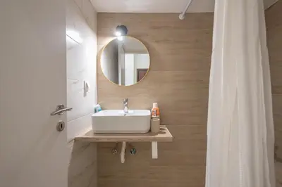 a bathroom with a sink and a mirror at Ble Elia Monastiraki Suite in Athens