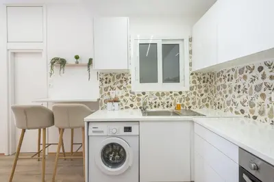 a white kitchen with a washing machine and a sink at Ble Elia Monastiraki Suite in Athens