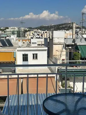 a view of a city from a balcony at Athens sky & Acropolis view rooftop apartment! in Athens