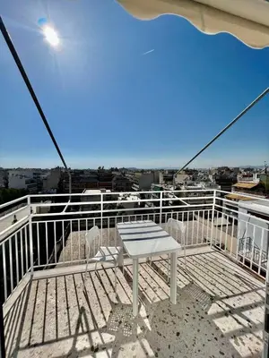 a balcony with a table and chairs on a ship at Athens sky & Acropolis view rooftop apartment! in Athens