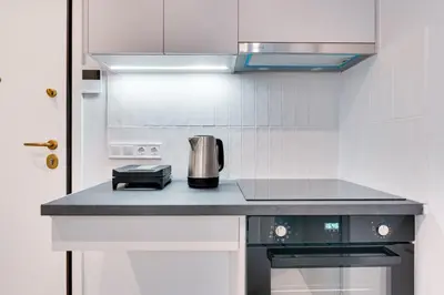 a kitchen with a counter with a coffee pot on it at Honey studio at Kypseli in Athens