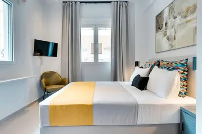 a bedroom with a large bed and a window at Honey studio at Kypseli in Athens