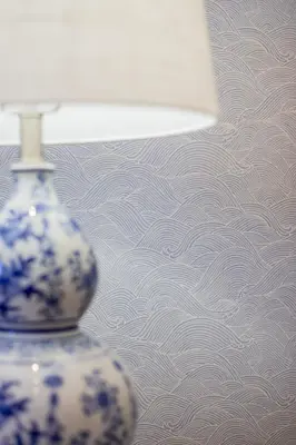 a blue and white vase sitting next to a lamp at Stylish 2BR-2BA condo in Glifada in Athens