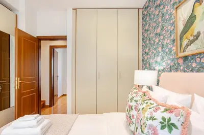 a bedroom with a bed with a lamp on it at Stylish 2BR-2BA condo in Glifada in Athens