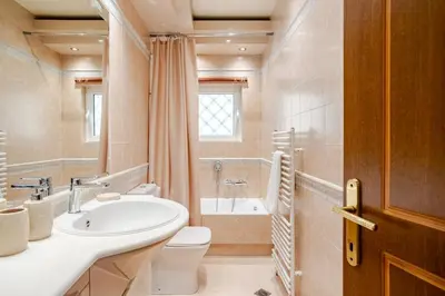 a bathroom with a sink and a toilet and a tub at Stylish 2BR-2BA condo in Glifada in Athens