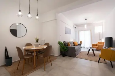 a living room with a table and a couch at 1BR Modern & Cozy Apt Near Metro and Acropolis in Athens