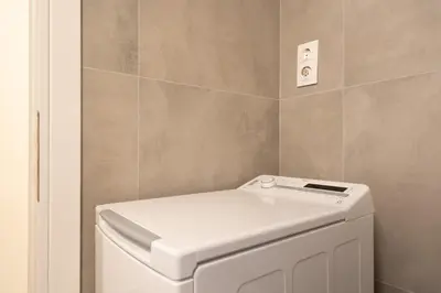 a white washer and dryer in a bathroom at 1BR Modern & Cozy Apt Near Metro and Acropolis in Athens