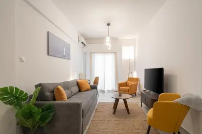 a living room with a couch and a tv at 1BR Modern & Cozy Apt Near Metro and Acropolis in Athens
