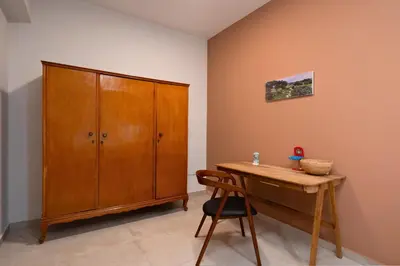 a room with a wooden cabinet and a wooden desk at 2BR Luxurious Apt in Mets 20 min From Acropolis in Athens