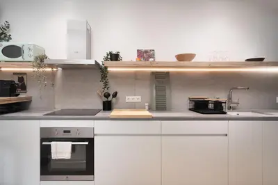 a kitchen with white cabinets and a sink at 2BR Luxurious Apt in Mets 20 min From Acropolis in Athens