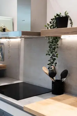 a kitchen counter with a wooden spoon and a plant at 2BR Luxurious Apt in Mets 20 min From Acropolis in Athens