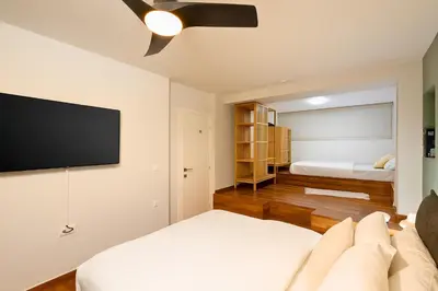 a living room with a couch and a flat screen tv at 2BR Luxurious Apt in Mets 20 min From Acropolis in Athens
