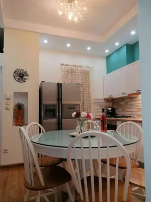 a kitchen with a table and chairs and a refrigerator at SOKRATESg in Athens