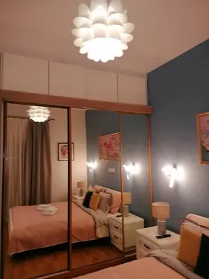 a bedroom with two beds and a large mirror at SOKRATESg in Athens