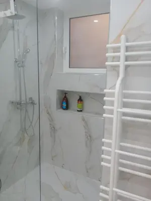 a bathroom with a shower with a glass door at SOKRATESg in Athens